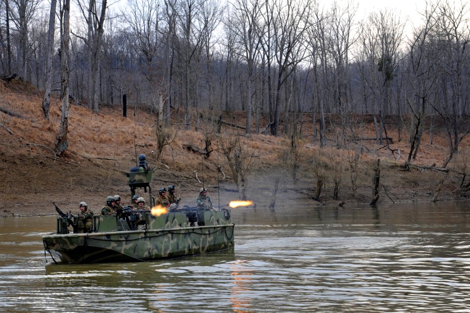 US Navy 100324-N-3136P-212 A riverine assault boat assigned to Riverine Squadron (RIVRON) 1 provides cover while Riverine Security Team takes control of the shore during a six-day field exercise at Ft. Knox, Ky