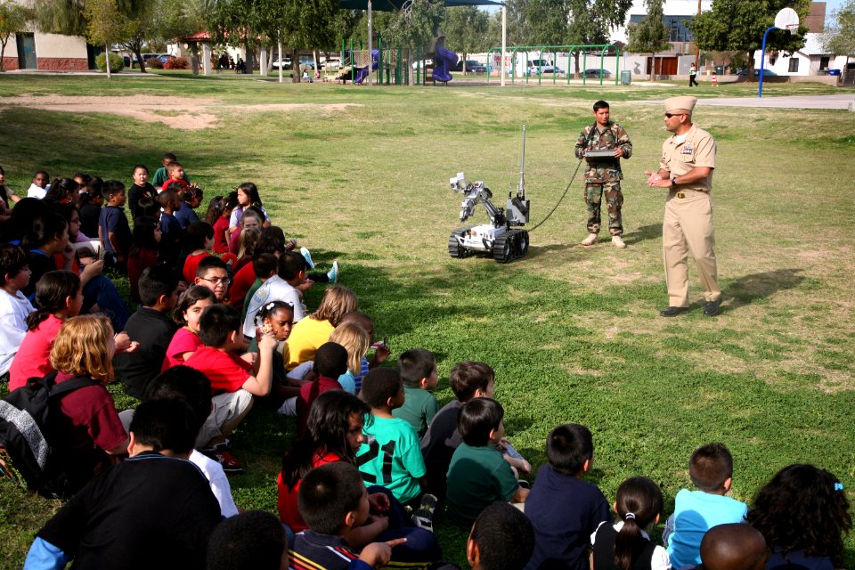 US Navy 100324-N-3271W-204 Members of Explosive Ordnance Disposal Mobile Unit (EODMU) 3, Det. China Lake demonstrate a remote-controlled robot used to investigate and handle explosive devices to children at Tri-City West Boys a