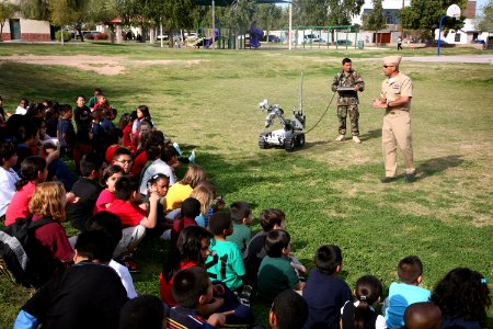 US Navy 100324-N-3271W-204 Members of Explosive Ordnance Disposal Mobile Unit (EODMU) 3, Det. China Lake demonstrate a remote-controlled robot used to investigate and handle explosive devices to children at Tri-City West Boys a photo