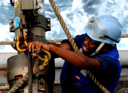 US Navy 100324-N-7948C-235 Aviation Ordnanceman Airman Raymond Thomas unhooks a span line from a re-fueling hose during an underway replenishment
