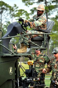 US Navy 100326-N-7367K-002 Equipment Operator 1st Class Robert Young, assigned to Naval Mobile Construction Battalion (NMCB) 23, operates a paver during Equipment Operator Advanced School at Naval Construction Battalion Center photo