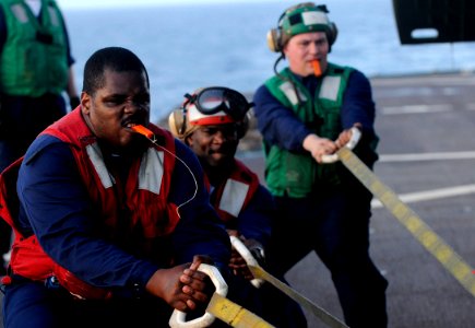 US Navy 100323-N-7478G-274 Sailors pull an SH-60F Sea Hawk helicopter across the flight deck of the U.S. 7th Fleet command ship USS Blue Ridge (LCC 19)