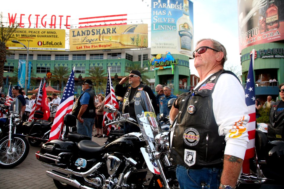 US Navy 100325-N-3271W-053 Members of the Patriot Guard Riders, a motorcycle group dedicated to supporting American service members, pause for the national anthem, sung by the U.S. Navy Band Southwest Destroyers
