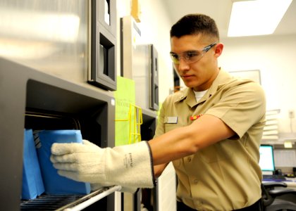 US Navy 100325-N-6326B-017 Hospital Corpsman 3rd Class Daniel Lopez removes heat purified dental tools from an autoclave