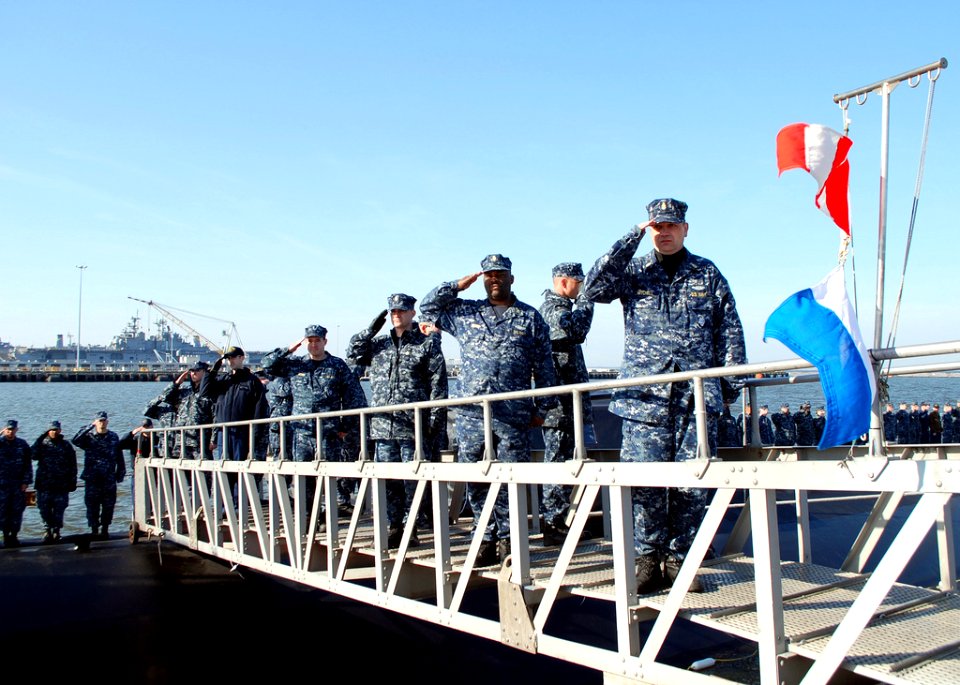 US Navy 100324-N-8750E-122 Sailors assigned to the Virginia-class attack submarine Pre-Commissioning Unit (PCU) New Mexico (SSN 779) salute during a commissioning ceremony rehearsal