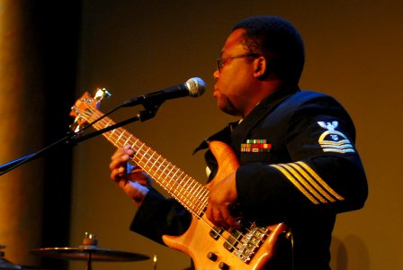 US Navy 100325-N-0773H-037 Chief Musician Benjamin Grant, music director of the U.S. Navy band ensemble, the Cruisers, plays bass guitar during an evening concert at the historic Patterson Theater in Baltimore, Md