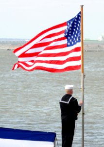 US Navy 100327-N-3154P-068 A Sailor raises the National Ensign during a commissioning ceremony aboard the Virginia-class attack submarine Pre-Commissioning (PCU) New Mexico (SSN 779) photo