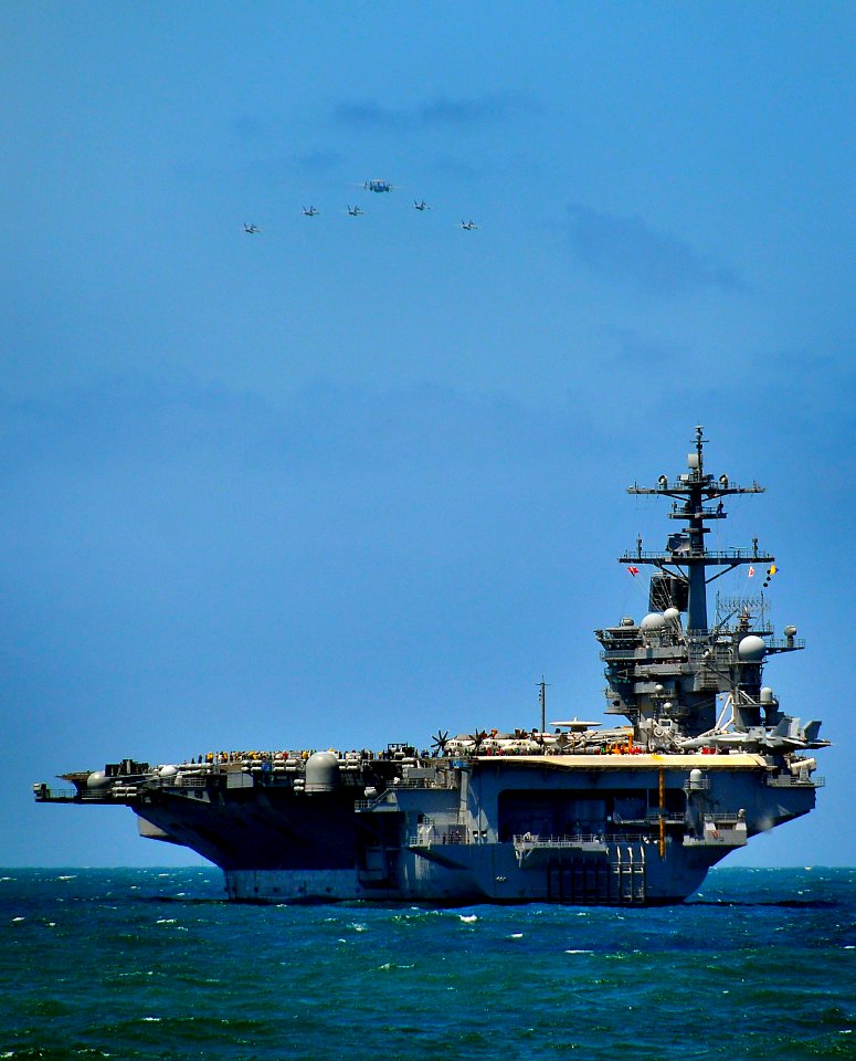 US Navy 100328-N-4774B-076 A formation of FA-18E Super Hornets fly over USS Carl Vinson (CVN 70)