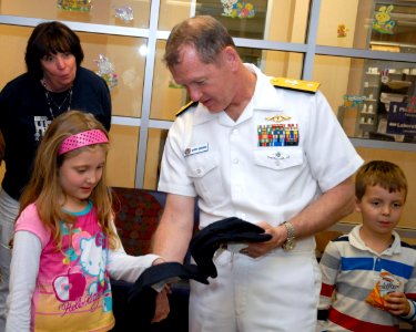 US Navy 100326-N-2389S-046 Rear Adm. Barry Bruner, commander of Submarine Group 10, hands out ball caps during a Caps for Kids event at a local Phoenix hospital during Phoenix Navy Week photo