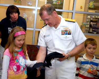 US Navy 100326-N-2389S-046 Rear Adm. Barry Bruner, commander of Submarine Group 10, hands out ball caps during a Caps for Kids event at a local Phoenix hospital during Phoenix Navy Week