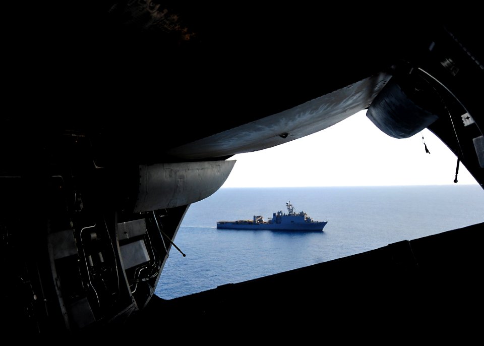 US Navy 100328-N-7948R-583 A CH-46 Sea Knight helicopter assigned to the amphibious assault ship USS Peleliu (LHA 5) flies over the amphibious dock landing ship USS Pearl Harbor (LSD 52) during flight operations