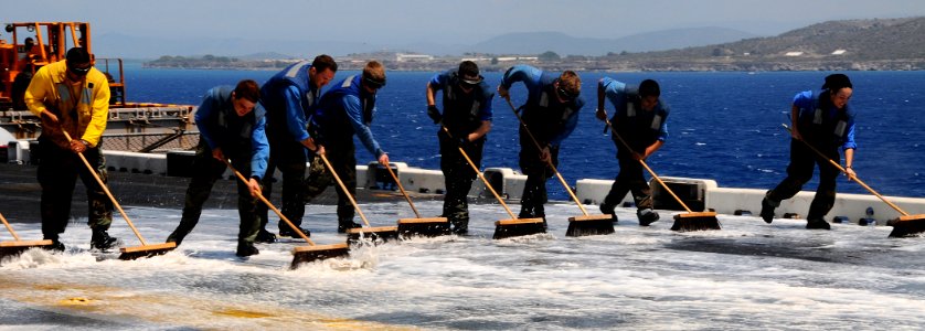 US Navy 100325-N-7508R-197 Sailors conduct an agricultural wash down on the flight deck of USS Bataan (LHD 5)