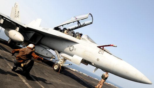 US Navy 100329-N-4236E-304 A Sailor signals the pilot of an F-A-18F Super Hornet assigned to the Jolly Rogers of Strike Fighter Squadron (VFA) 103