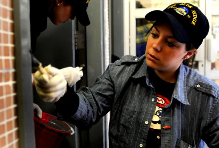 US Navy 100329-N-7280V-703 Ship's Serviceman Seaman Breanne Markey assigned to the U.S. 7th Fleet command ship USS Blue Ridge (LCC 19), paints a doorways at Po Leung Kuk-Wong Chuk Hang, a care center for the elderly