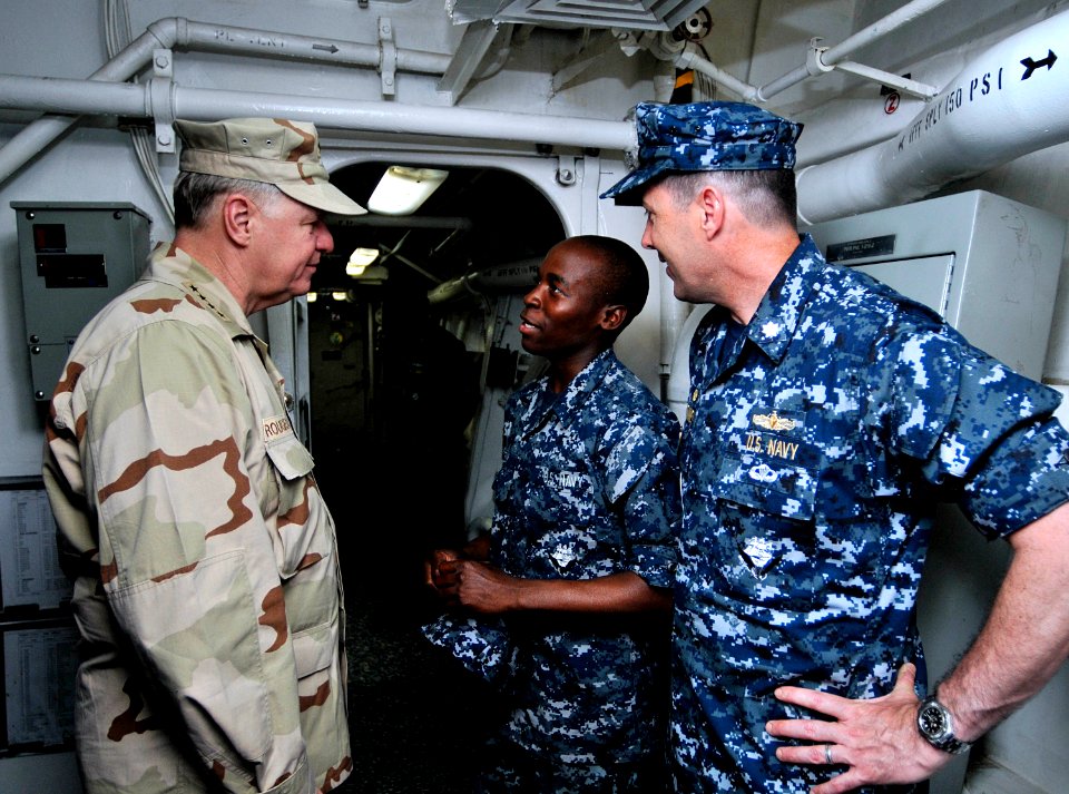 US Navy 100326-N-8273J-262 Chief of Naval Operations (CNO) Adm. Gary Roughead, left, and Cmdr. Ed Devinney, commanding officer of the guided-missile destroyer USS Cole (DDG 67), thank Sailors for their hard work while deployed