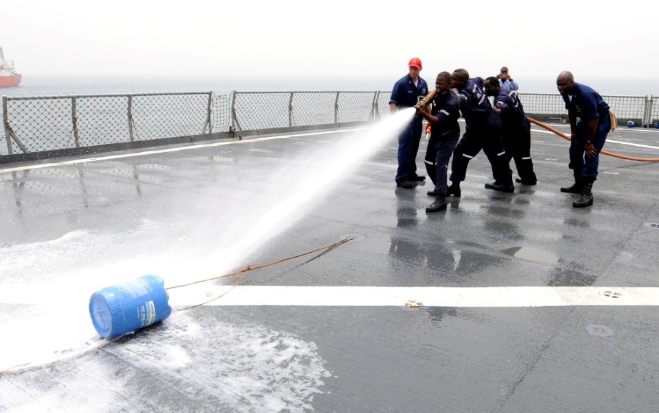 US Navy 100326-N-6676S-043 A fire team of Nigerian, Ghanaian, Benin, and Togolese sailors fights a simulated fire during a final exercise to test their knowledge of basic damage control and first aid aboard the amphibious dock