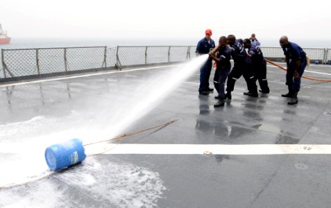 US Navy 100326-N-6676S-043 A fire team of Nigerian, Ghanaian, Benin, and Togolese sailors fights a simulated fire during a final exercise to test their knowledge of basic damage control and first aid aboard the amphibious dock