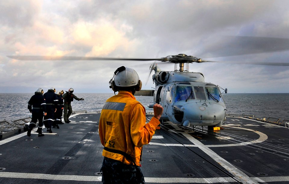US Navy 100327-N-4774B-157 Boatswain's Mate 3rd Class Alexander Black, from Quinlin, Texas, directs an SH-60F Sea Hawk helicopter assigned to the Red Lions of Helicopter Anti-submarine Squadron (HS) 15