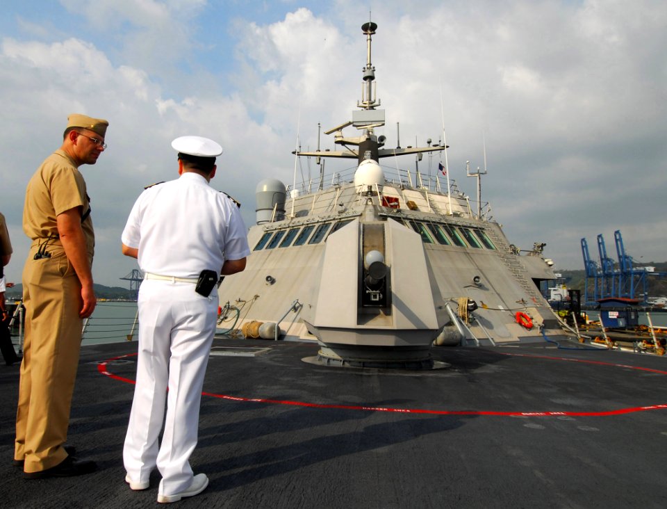US Navy 100326-N-7058E-249 Lt. Cmdr. Matt Weber, executive officer of the littoral combat ship USS Freedom (LCS 1), describes the ship's Mk 110 57mm gun