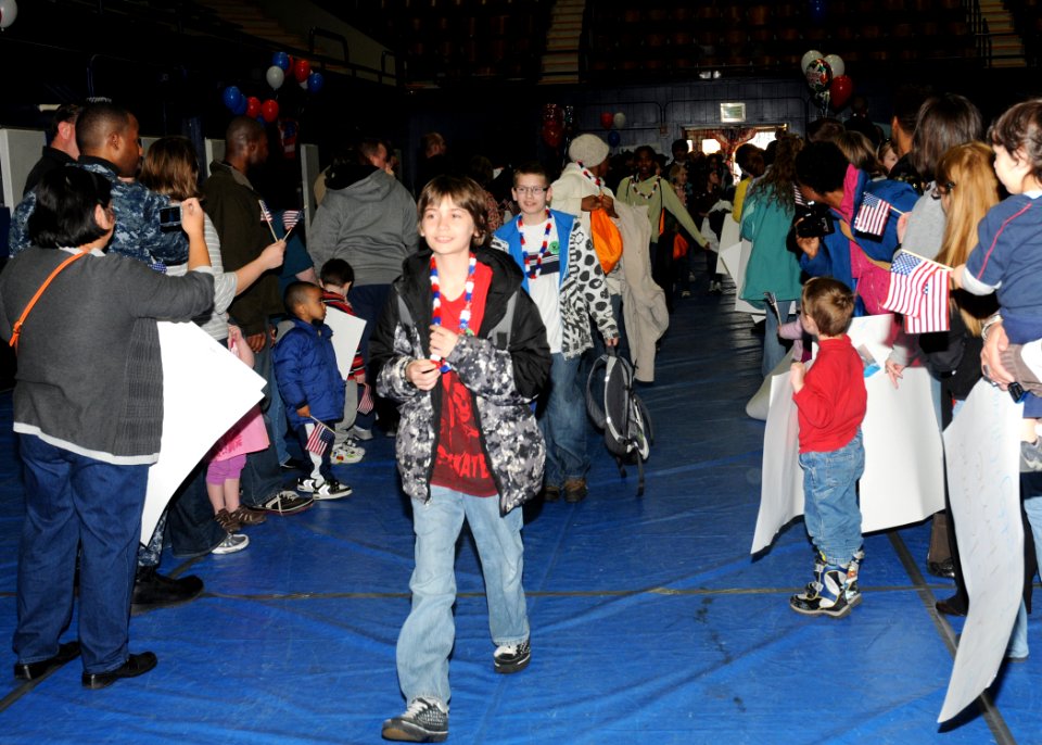 US Navy 100401-N-4649C-001 Children are greeted to a homecoming celebration after returning from a Kids' Day Deployment
