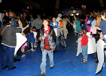 US Navy 100401-N-4649C-001 Children are greeted to a homecoming celebration after returning from a Kids' Day Deployment