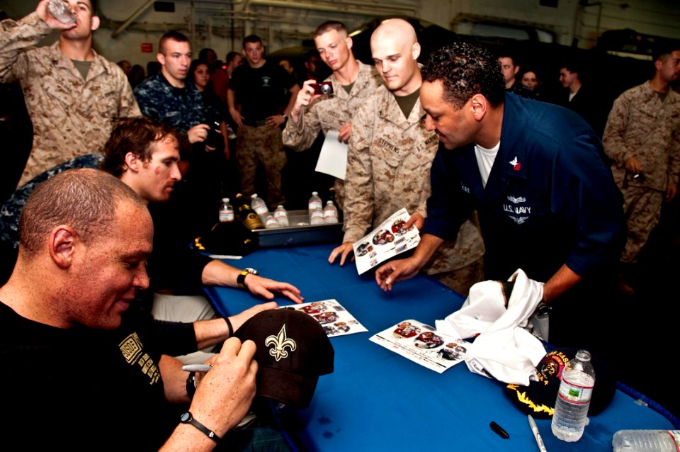 US Navy 100328-N-8936G-226 ew Orleans Saints tight end Billy Miller and New Orleans Saints quarterback Drew Brees sign autographs for Sailors and Marines aboard USS Nassau (LHA 4)