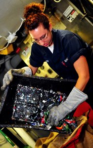 US Navy 100329-N-7317W-003 Machinist's Mate Fireman Sherene Aun sorts metal to be properly disposed