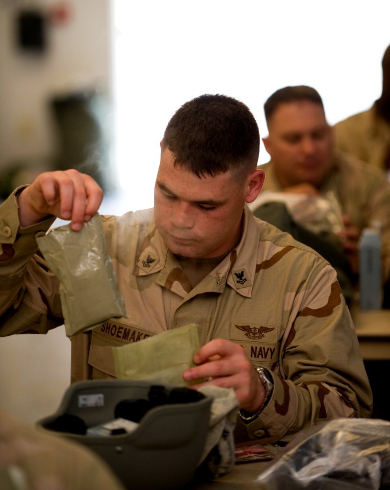 US Navy 100329-N-6932B-781 Air Traffic Controller 2nd Class David Allen Shoemaker experiences his first meal-ready-to-eat (MRE) during the U.S. Navy Individual Augmentee Combat Training course at Fort Jackson, S.C