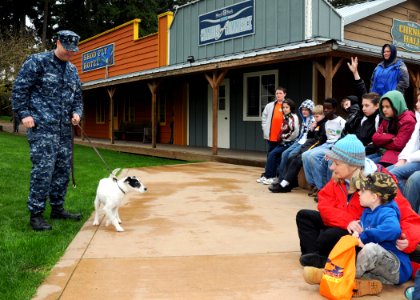 US Navy 100401-N-4649C-004 Children participating in a Kids' Day Deployment meet Zorro, a military working dog and his handler, Master-At-Arms 1st Class Josh Vanorden, from Naval Base Kitsap Security photo