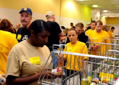 US Navy 100329-N-3165S-007 Chief petty officers from the Hampton Roads area volunteer their time at the food bank of Southeastern Virginia, sorting food products to be delivered to those in need