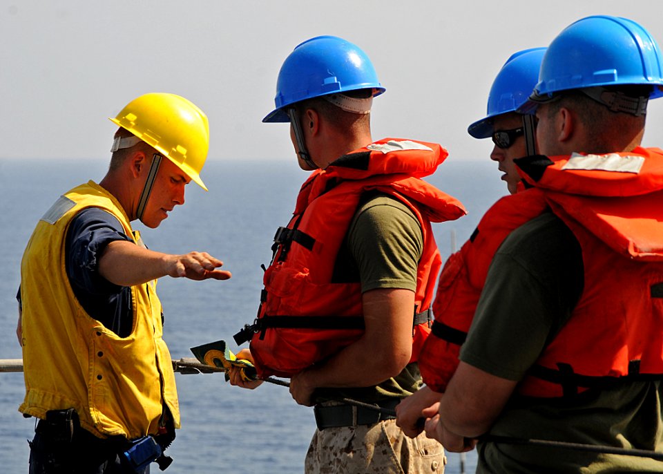 US Navy 100329-N-1082Z-048 Boatswain's Mate 3rd Class Justin K. Pradt instructs Marines as they handle the phone and distance line aboard USS Ashland (LSD 48)