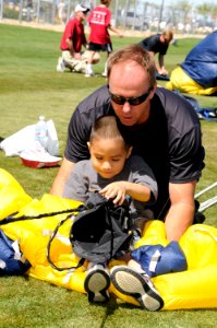 US Navy 100327-N-5366K-135 James Woods lets a child help deflate his parachute photo