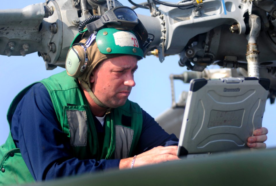 US Navy 100402-N-1675O-065 Aviation Machinist's Mate 1st Class David Wilbur troubleshoots a maintenance problem on an SH-60F Sea Hawk helicopter aboard the U.S. 7th Fleet command ship USS Blue Ridge (LCC 19)