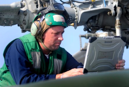 US Navy 100402-N-1675O-065 Aviation Machinist's Mate 1st Class David Wilbur troubleshoots a maintenance problem on an SH-60F Sea Hawk helicopter aboard the U.S. 7th Fleet command ship USS Blue Ridge (LCC 19)