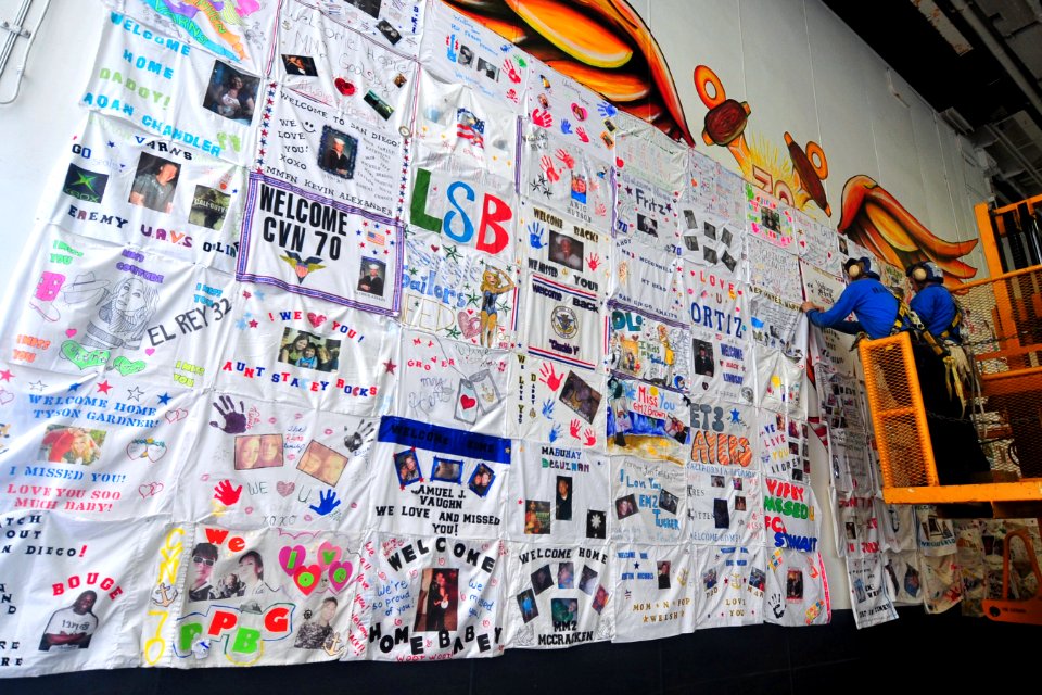 US Navy 100403-N-2953W-012 Sailors aboard the aircraft carrier USS Carl Vinson (CVN 70), make a mosaic display of t-shirt messages sent from loved ones