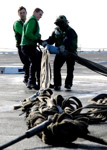 US Navy 100403-N-3885H-109 Sailors assigned to the air department of the aircraft carrier USS George H.W. Bush (CVN 77) take down the aircraft barricade during a drill on the flight deck