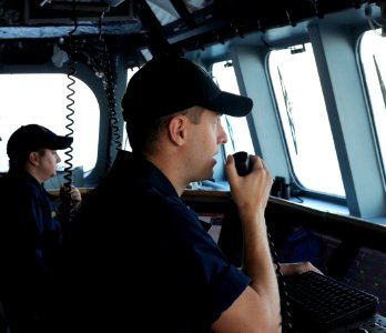 US Navy 100402-N-7653W-060 Lt. j.g. Justin Guernsey communicates on the ship's VHF radio while standing watch on the bridge of the littoral combat ship USS Independence (LCS 2)
