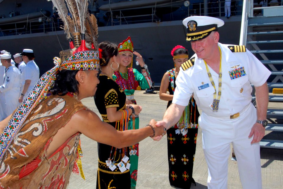 US Navy 100403-N-5086M-157 Capt. Rudy Luptin, commanding officer of the U.S. 7th Fleet command ship USS Blue Ridge (LCC 19), is greeted by a Malaysian native upon the ships arrival in Sepangar, Malaysia