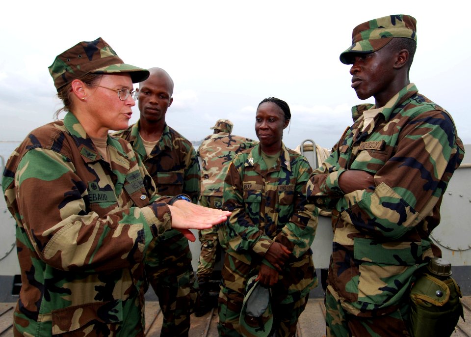 US Navy 100403-N-6138K-931 Capt. Cindy Thebaud, commander of Africa Partnership Station (APS) West, speaks to Armed Forces of Liberia Coast Guardsmen while transiting to the amphibious dock-landing ship USS Gunston Hall (LSD 44