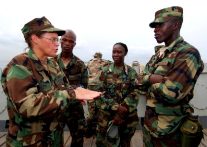 US Navy 100403-N-6138K-931 Capt. Cindy Thebaud, commander of Africa Partnership Station (APS) West, speaks to Armed Forces of Liberia Coast Guardsmen while transiting to the amphibious dock-landing ship USS Gunston Hall (LSD 44