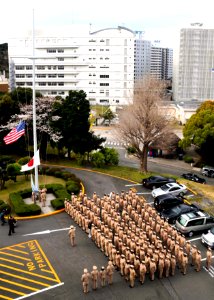 US Navy 100401-N-3283P-005 Members of the Far East Chief Petty Officer Mess observe morning colors to commemorate the 117th anniversary of the establishment of the chief petty officer rank photo