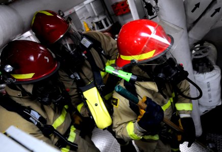 US Navy 100331-N-7280V-270 Sailors use a naval firefighting thermal imager (NFTI) to assess a simulated casualty during an engine room fire drill photo