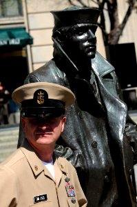 US Navy 100401-N-9818V-009 Master Chief Petty Officer of the Navy (MCPON) Rick West stands by the Lone Sailor statue photo