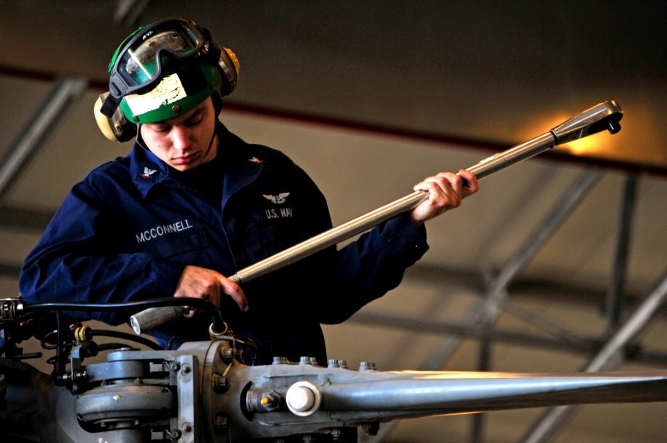 US Navy 100406-N-7364R-087 Aviation Machinist's Mate 3rd Class Jason McConell uses a torque wrench on the main rotor head of an MH-60S Sea Hawk helicopter