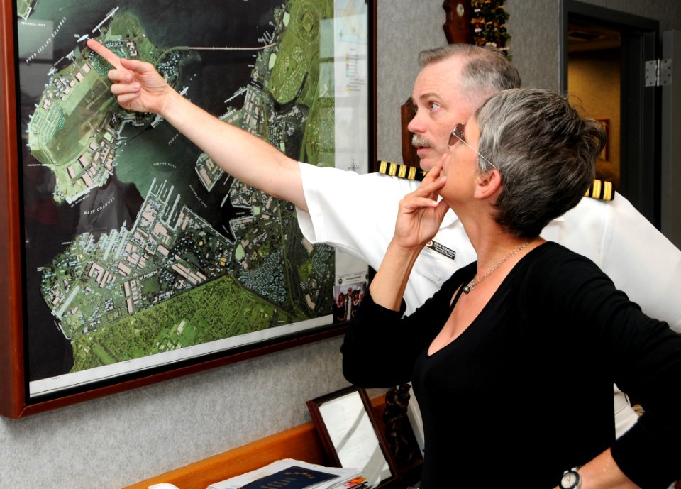 US Navy 100401-N-3666S-092 Capt. Richard Kitchens, commander of Joint Base Pearl Harbor-Hickam, shows actress Jamie Lee Curtis a map of Pearl Harbor