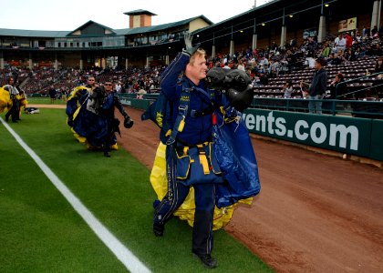 US Navy 100402-N-5366K-249 Aircrew Survival Equipmentman 1st Class Thomas Kinn, assigned to the U.S. Navy demonstration parachute team, the Leap Frogs, waves to spectators