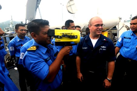 US Navy 100401-N-8335D-674 Damage Controlman 2nd Class Titan Brockopp shows Royal Malaysian navy sailors a Navy infrared thermal imager