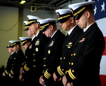 US Navy 100407-N-4236E-232 Officers bow their heads aboard the aircraft carrier USS Dwight D. Eisenhower (CVN 69) during a memorial service for Lt. Steven Zilberman