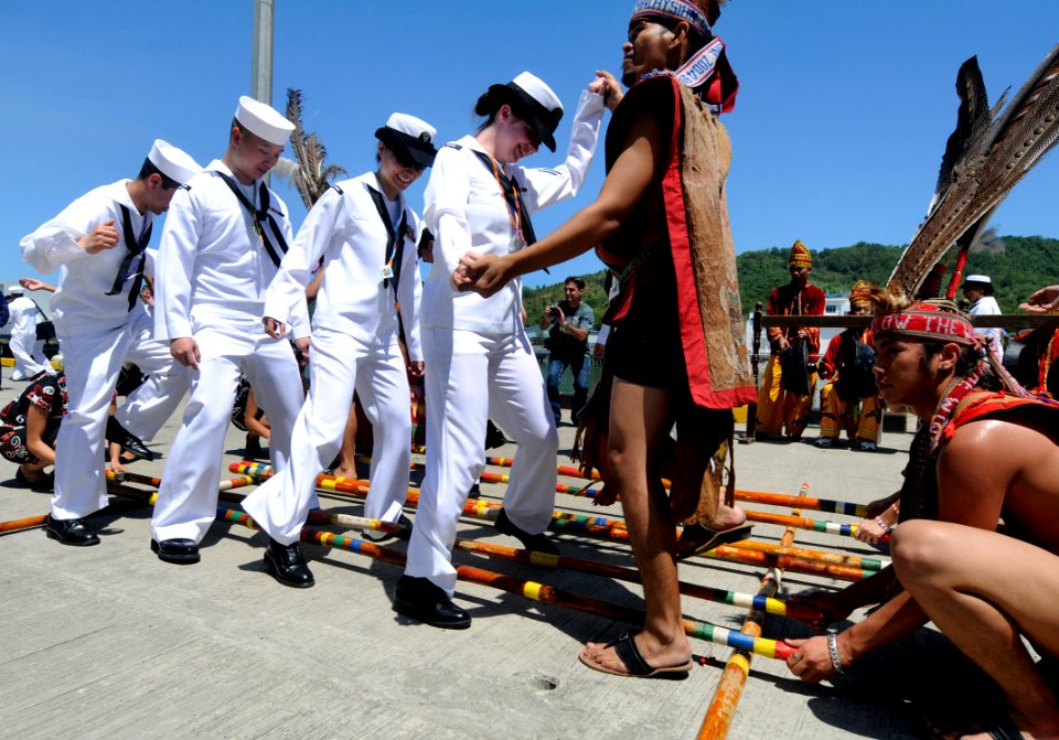 US Navy 100403-N-7280V-484 Culinary Specialist Seaman Dulce Looney and fellow Sailors dance with traditional Malay dancers