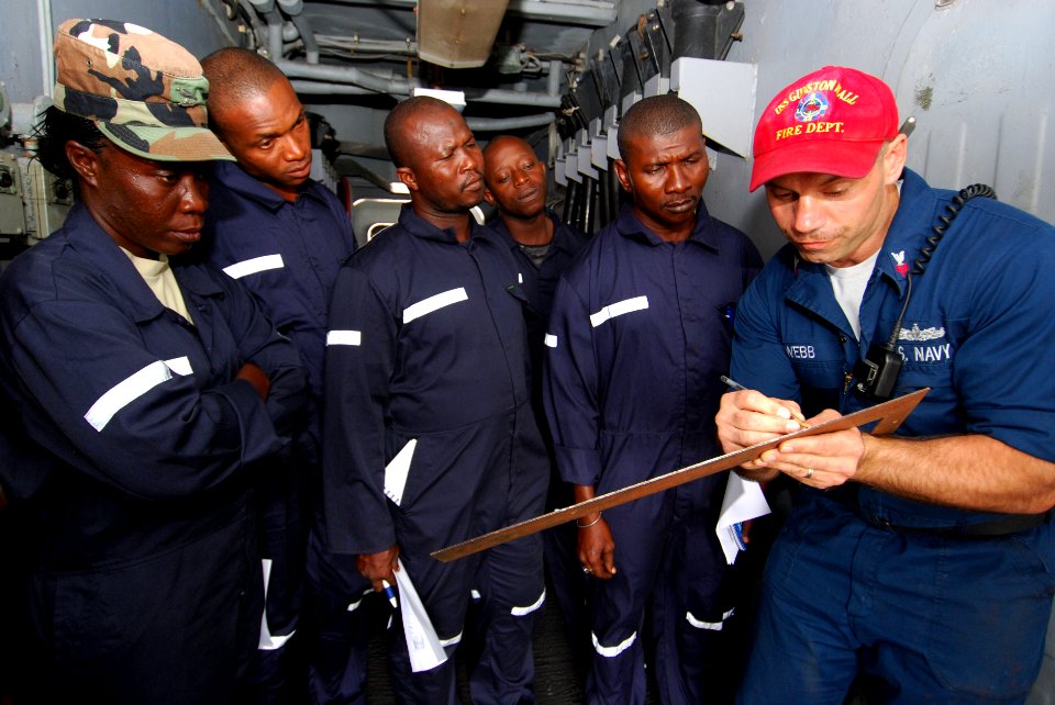 US Navy 100407-N-6138K-005 Damage Controlman 1st Class Corry Webb, from Dearborn Heights, Mich., teaches sailors from Gambia, Liberia, and Sierra Leone the proper procedure for measuring shoring